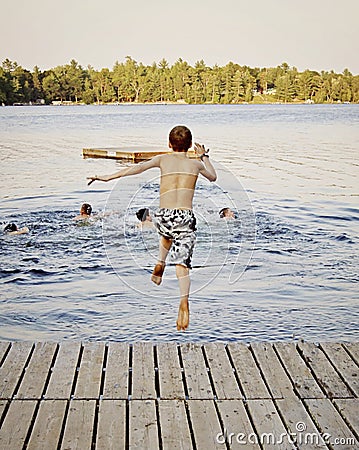 Boy jumping into lake Stock Photo