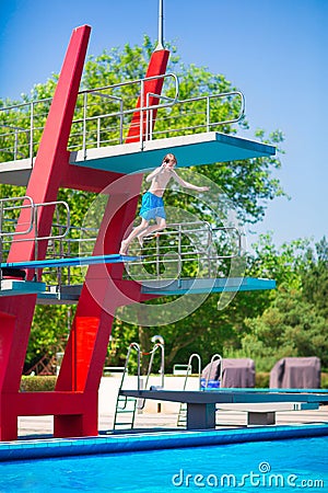 Boy jumping into a pool Stock Photo