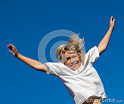 Boy jumping on a trampoline Stock Photo