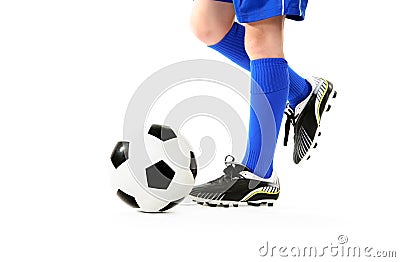 Boy kicking soccer ball Stock Photo