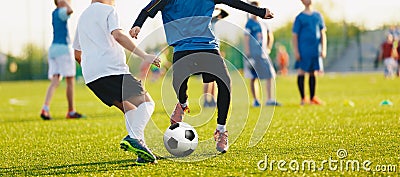 Boy kicking soccer ball. Close up action of boys soccer teams, aged 8-10, playing a football match Stock Photo