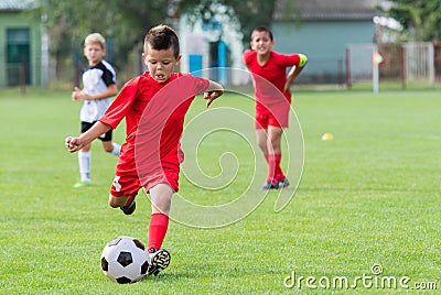 Boy kicking soccer ball Stock Photo