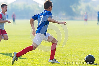 Boy kicking soccer ball Stock Photo