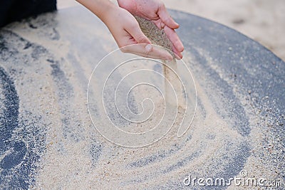 Boy kid playing with sand on the playground, the concept of the development of fine motor skills, tactile sensations, creativity, Stock Photo