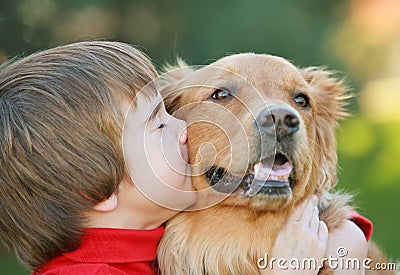 Boy Kissing Dog Stock Photo