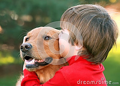 Boy Kissing Dog Stock Photo