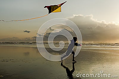 Boy with Kite at sunset. Stock Photo