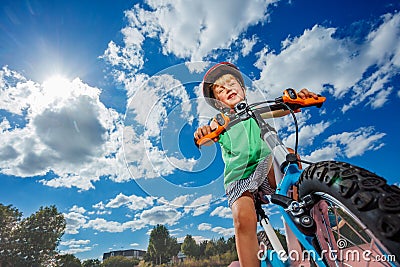 Boy on little bicycle riding at park portrait over sky Stock Photo