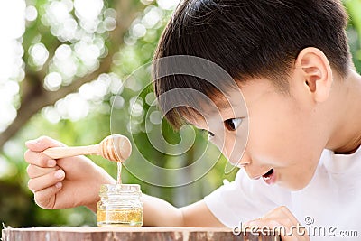 Boy look at honey comb Stock Photo