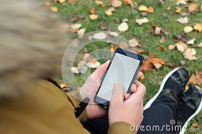 Boy looking at a smart-phone Stock Photo