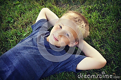 Boy Lying in Grass Stock Photo