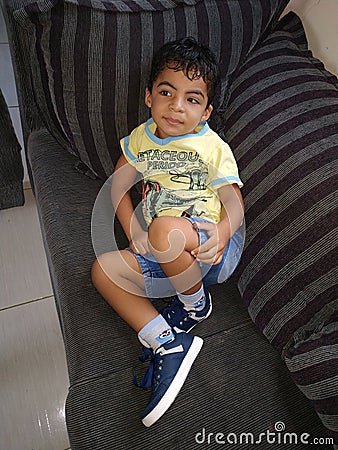 boy lying on sofa Stock Photo