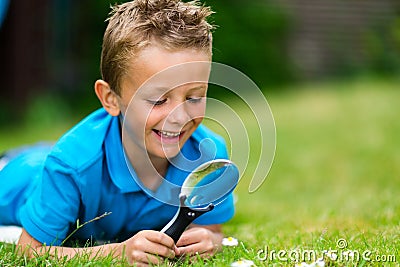 Boy with magnifier Stock Photo