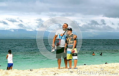 Boy and man on the beach Stock Photo