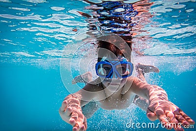 Boy in mask dive in swimming pool Stock Photo