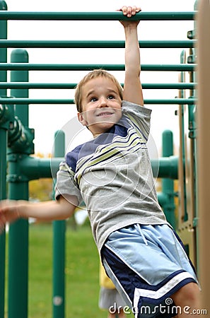 Boy on Monkey Bars Stock Photo