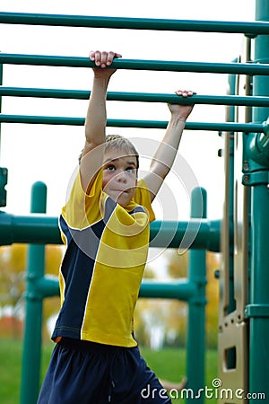 Boy on Monkey Bars Stock Photo