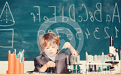 Boy near microscope and test tubes school classroom. Knowledge concept. Knowledge day. Kid study biology chemistry Stock Photo