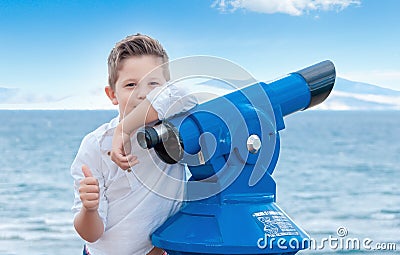 Boy near the scoping public binocular telescope binoscope near Stock Photo