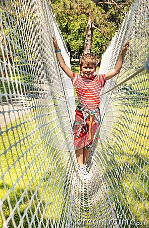 Boy on the net in adventure rope climbing park Stock Photo