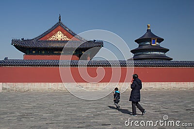 A boy and an old woman passing by the Temple of Heaven in Beijing Editorial Stock Photo