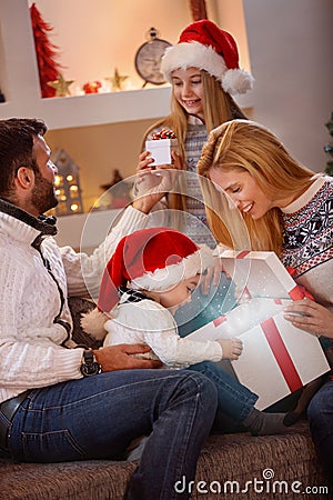 Boy open magical Christmas gift-box with family Stock Photo