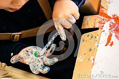 Boy with paint stained hands Stock Photo