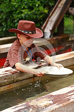 Boy panning for gold Stock Photo