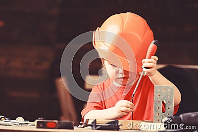 Boy play as builder or repairer, work with tools. Child dreaming about future career in architecture or building Stock Photo