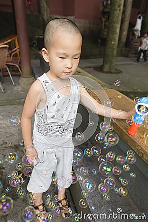 Boy play soapbubbles Stock Photo