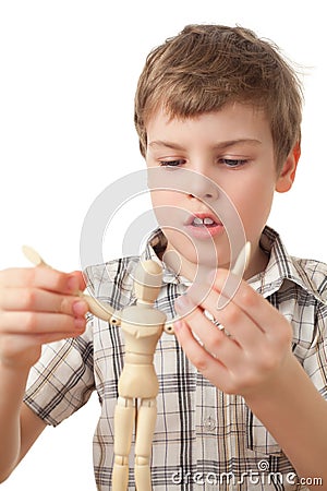 Boy is played by wooden little manikin Stock Photo