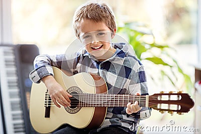 Boy playing acoustic guitar Stock Photo