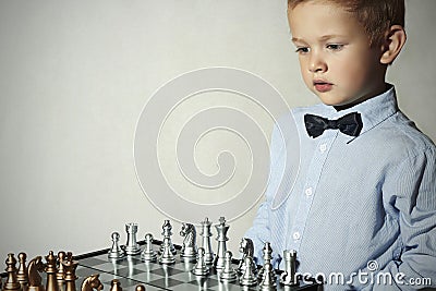 Boy playing chess.Smart kid.Little genius Child. Intelligent game.Chessboard Stock Photo