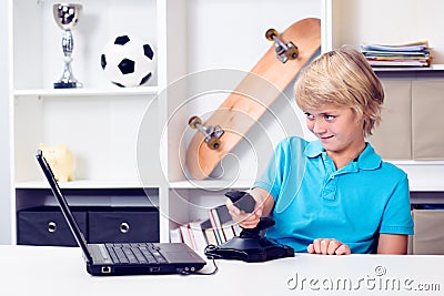 Boy is playing computer game Stock Photo