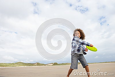 Boy playing frisbee on beach Stock Photo