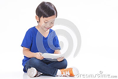 Boy playing a game on computer tablet Stock Photo