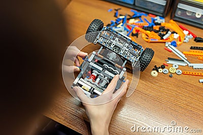 Boy playing with hi-tech constructor, making complex machine with many moving parts Stock Photo