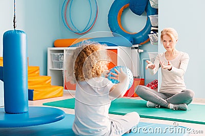 Boy playing with his therapist Stock Photo