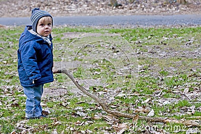 Boy playing with long stick Stock Photo