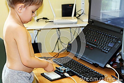 Boy playing with microcontroller Stock Photo