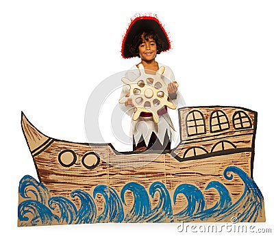 Boy playing pirate no cardboard ship steering Stock Photo