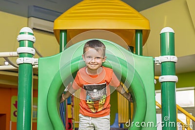 Boy playing on the playground, in the children`s maze. Cute boy having fun on playground Stock Photo