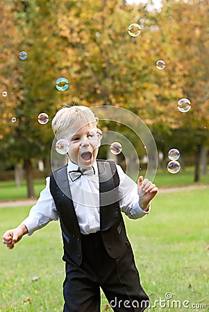 Boy playing with soap bubbles Stock Photo