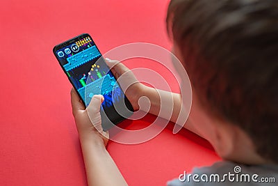 Boy playing Super Mario Run mobile game on Samsung Galaxy S9 plus phone close-up Editorial Stock Photo