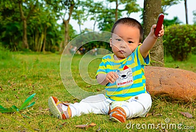 The boy playing in the Swiss Army knife on the lawn Stock Photo