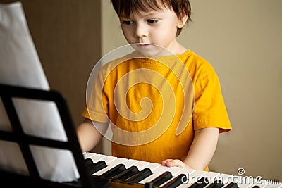A boy playing the synthesizer Stock Photo