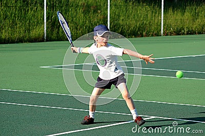 Boy playing tennis Stock Photo