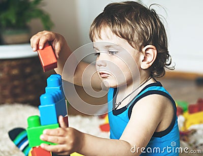 Boy playing with toy blocks and bricks Stock Photo