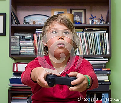 Boy playing a video game console. Stock Photo