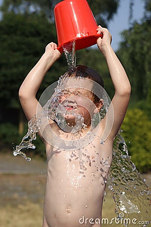 Boy playing with water Stock Photo